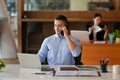 Young businesswoman working at table