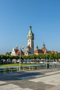 Buildings in city against blue sky, iconic lighthouse in sopot, poland. 