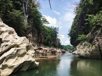 Scenic view of river amidst trees against sky