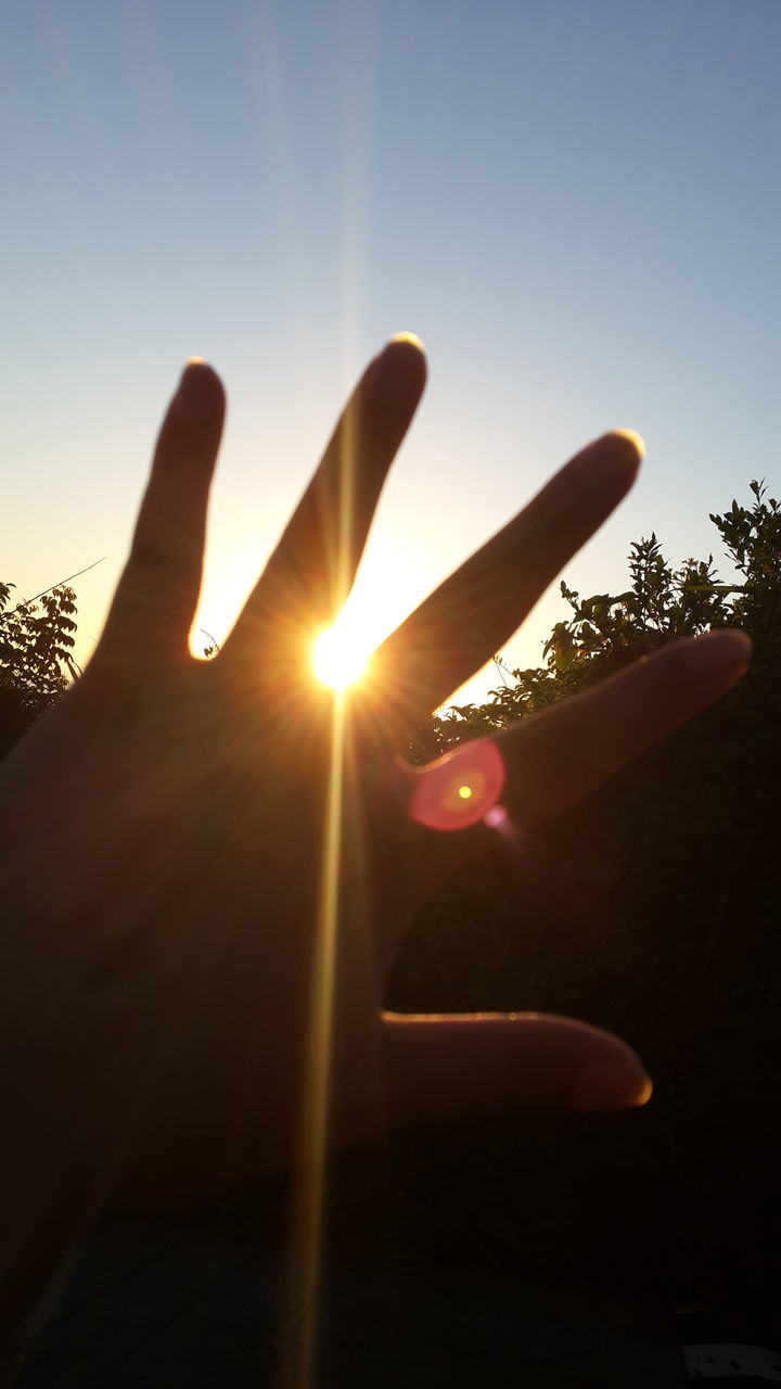 lifestyles, person, leisure activity, sun, sunlight, part of, holding, human finger, silhouette, sunbeam, lens flare, personal perspective, unrecognizable person, cropped, men