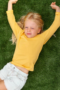 Portrait of smiling young woman exercising on field