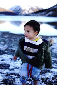 Portrait of boy standing at a lake