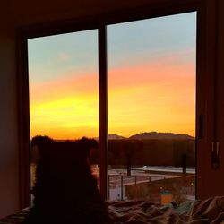 View of orange sky seen through window