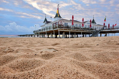 View of pier on beach against sky