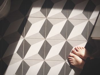 Top view of feet on tiled floor 