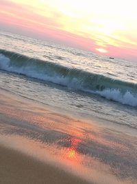 Scenic view of beach against sky during sunset