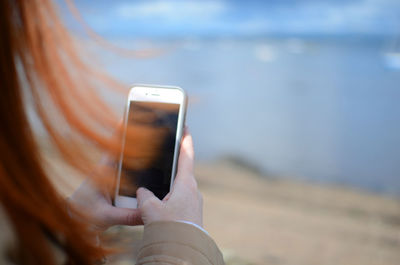 Close-up of hand holding mobile phone