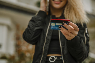 Young woman holding credit card