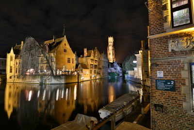 Reflection of buildings in river at night