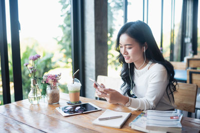 Young woman using laptop while sitting at home