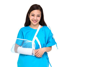 Portrait of a smiling young woman against white background