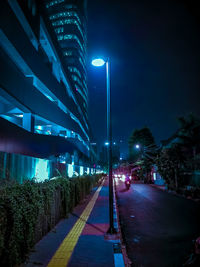 View of illuminated street lights at night