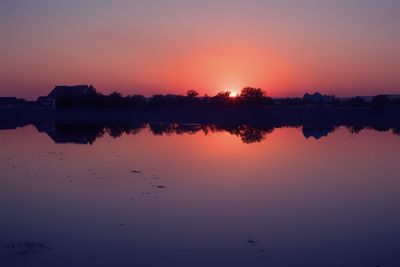 Scenic view of lake against romantic sky at sunset