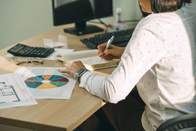 Calculating success, hands on strategies office productivity amidst diagrams, woman is plans profit