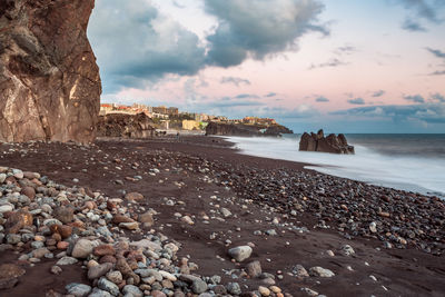 Rocks on beach against sky