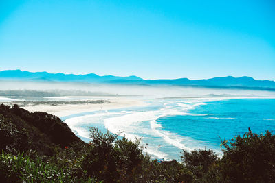 Scenic view of sea against clear blue sky