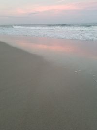 Scenic view of beach against sky during sunset