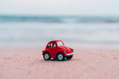 Close-up of toy car on beach