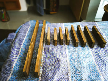 Woodworking, wood planks arranged on blue canvas in a workshop