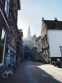 Street amidst buildings against sky in city