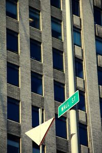 Low angle view of wall street sign against building