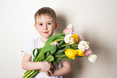 Close-up of cute girl holding flowers