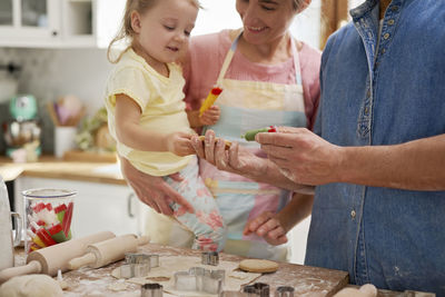 Family preparing food in kitchen