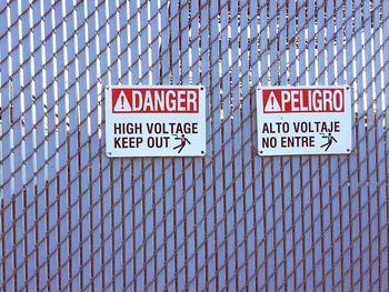 High voltage sign on fence