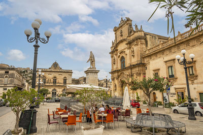 The beautiful busacca square in scicli with monument and church