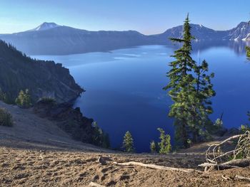 Scenic view of lake and mountains against clear sky