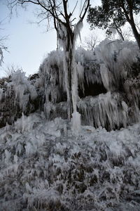 Scenic view of snow covered land against sky