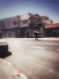 Rear view of woman in front of building