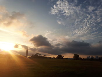 Scenic view of field against sky at sunset