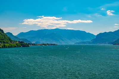 Scenic view of sea and mountains against sky