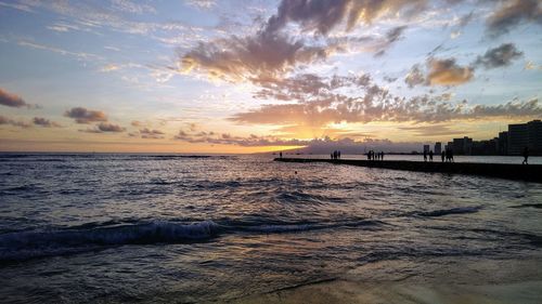 Scenic view of beach against sky during sunset