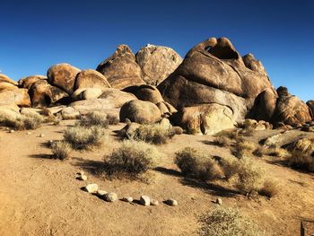 Rocks in desert against clear sky