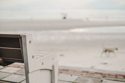 Close-up of railing by sea against sky