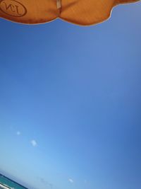 Low angle view of trees against clear blue sky