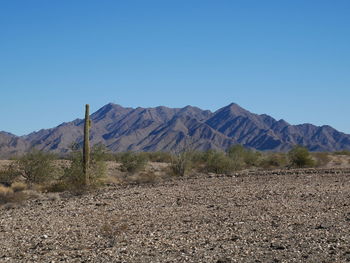 Scenic view of mountains against clear blue sky