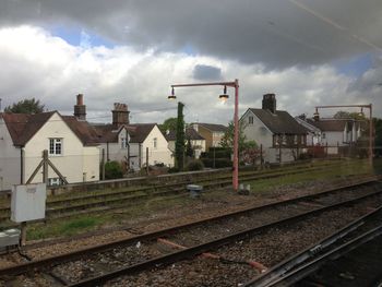 Railroad track against cloudy sky