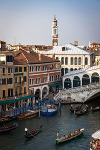 Boats in river with buildings in background