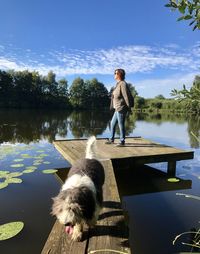 Woman with dog standing in lake