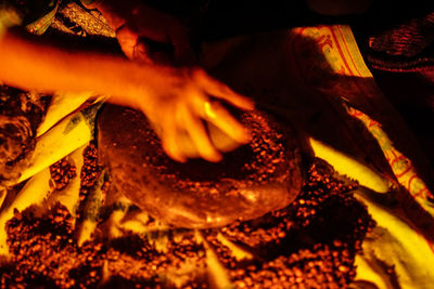 Close-up of hand holding burning candles
