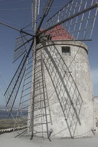 Low angle view of windmill against sky