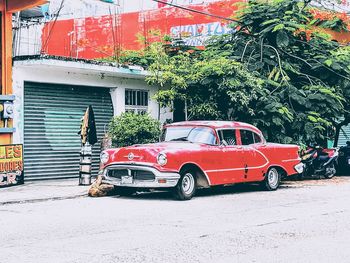 Car on road against buildings in city