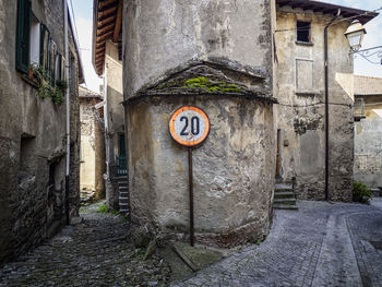 Road sign on old building in alley