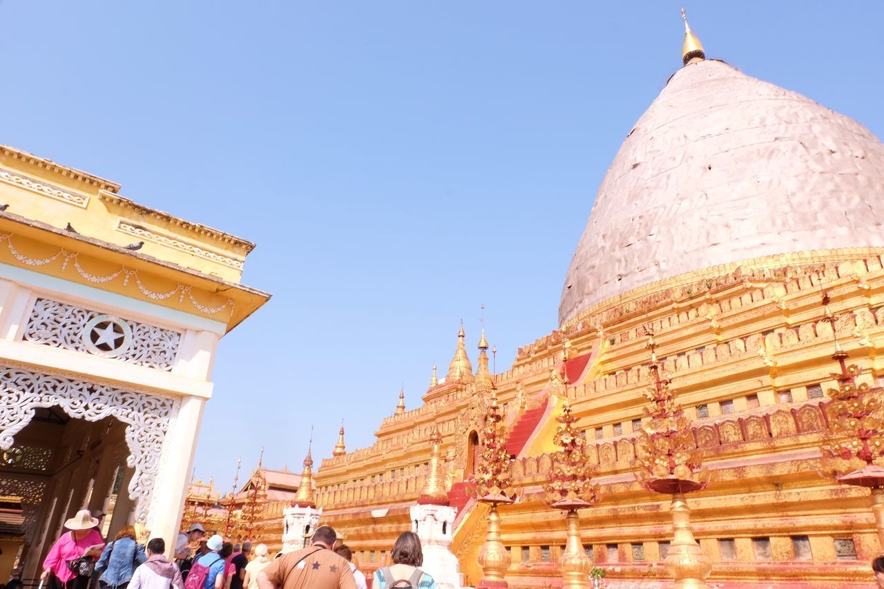 LOW ANGLE VIEW OF PEOPLE OUTSIDE TEMPLE AGAINST SKY