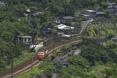 High angle view of train amidst buildings in city