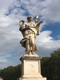 Low angle view of statue against cloudy sky