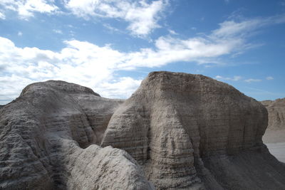 Low angle view of rock formations against sky